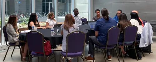 A group of people working together at a table during a CCCSE convening.