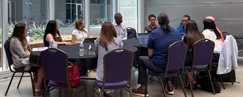 A group of people working together at a table during a CCCSE convening.
